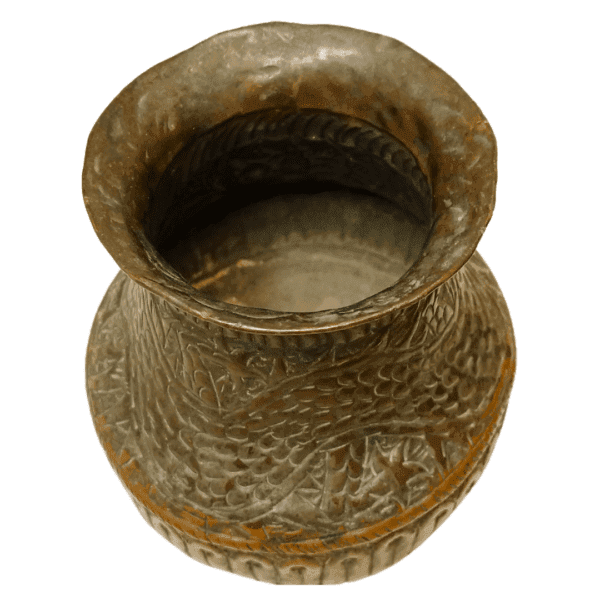 Handcrafted copper pot with intricate engravings.