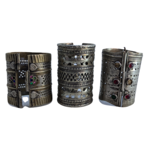 “Traditional handmade tribal bangles featuring detailed engraving and stone accents”