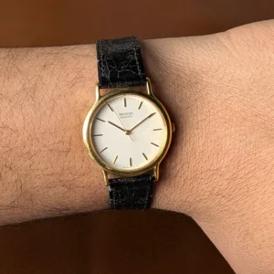 Close up Ricoh Japan quartz watch white minimalist dial on hand