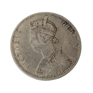 Front side of antique Queen Victoria silver rupee coin from British India with vintage patina and detailed royal portrait.