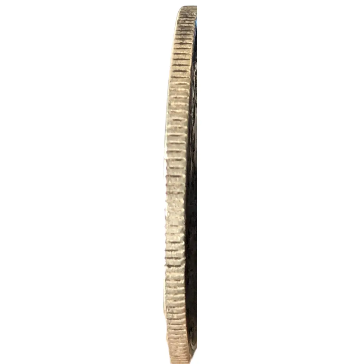 Reeded edge of original 1862 British India silver rupee coin showing thickness and side detail.