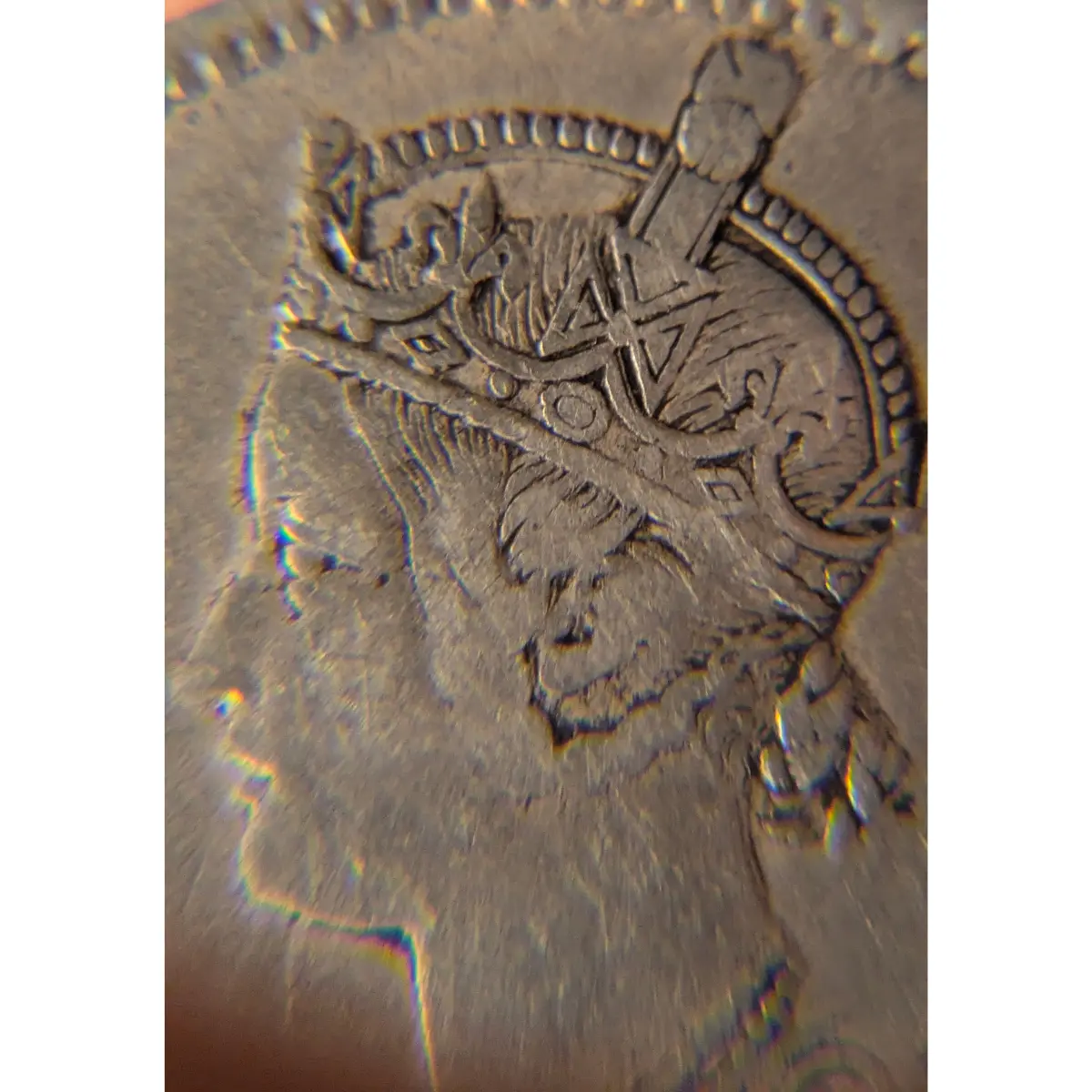Close-up portrait of Queen Victoria on an 1862 British India One Rupee silver coin showing detailed crown engraving.