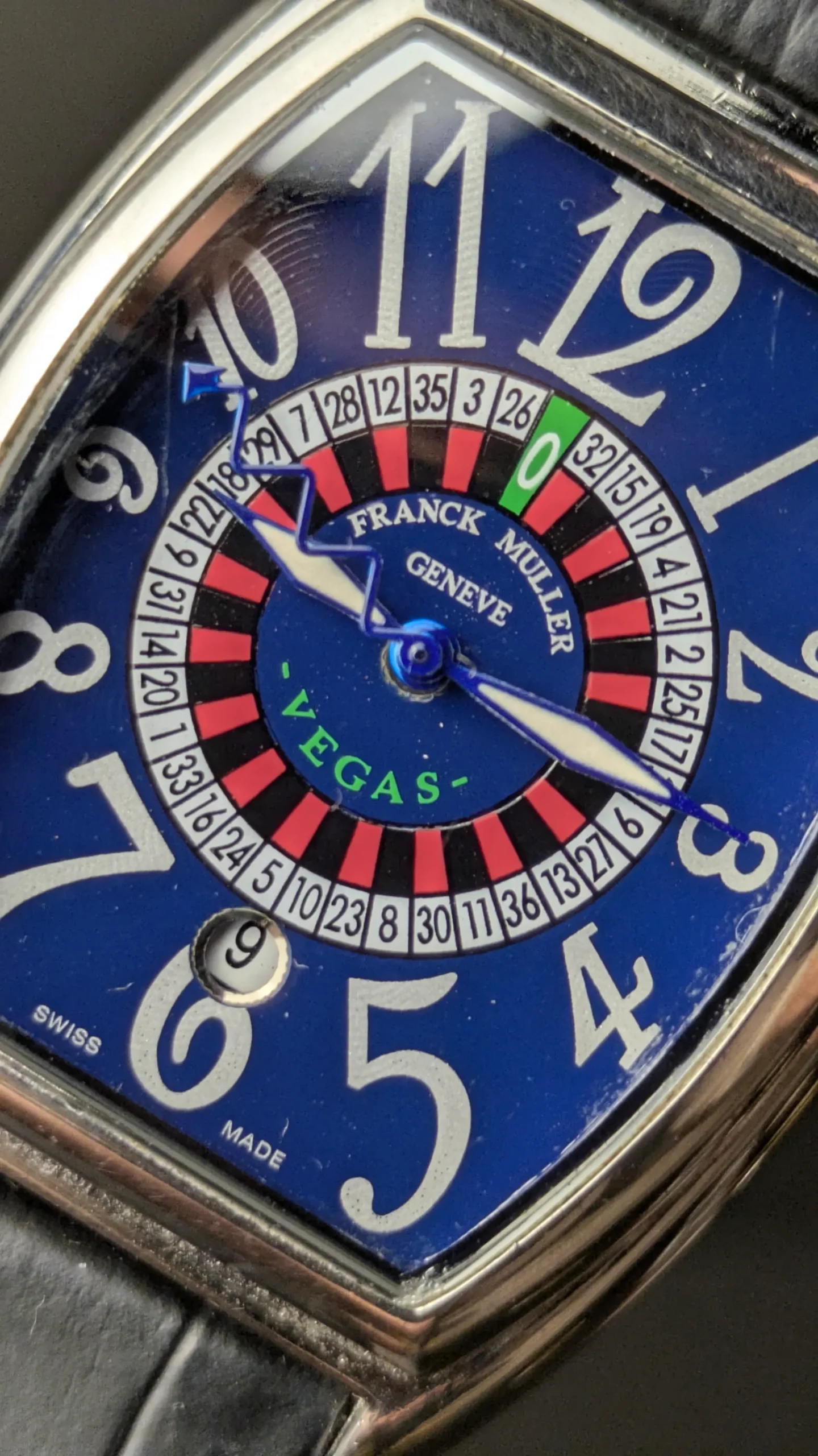 Blue roulette dial luxury wrist watch close up
