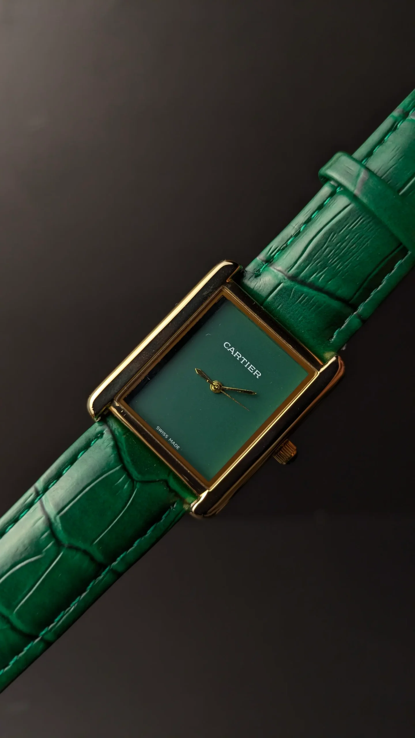 Rectangular gold tone dress watch with green strap