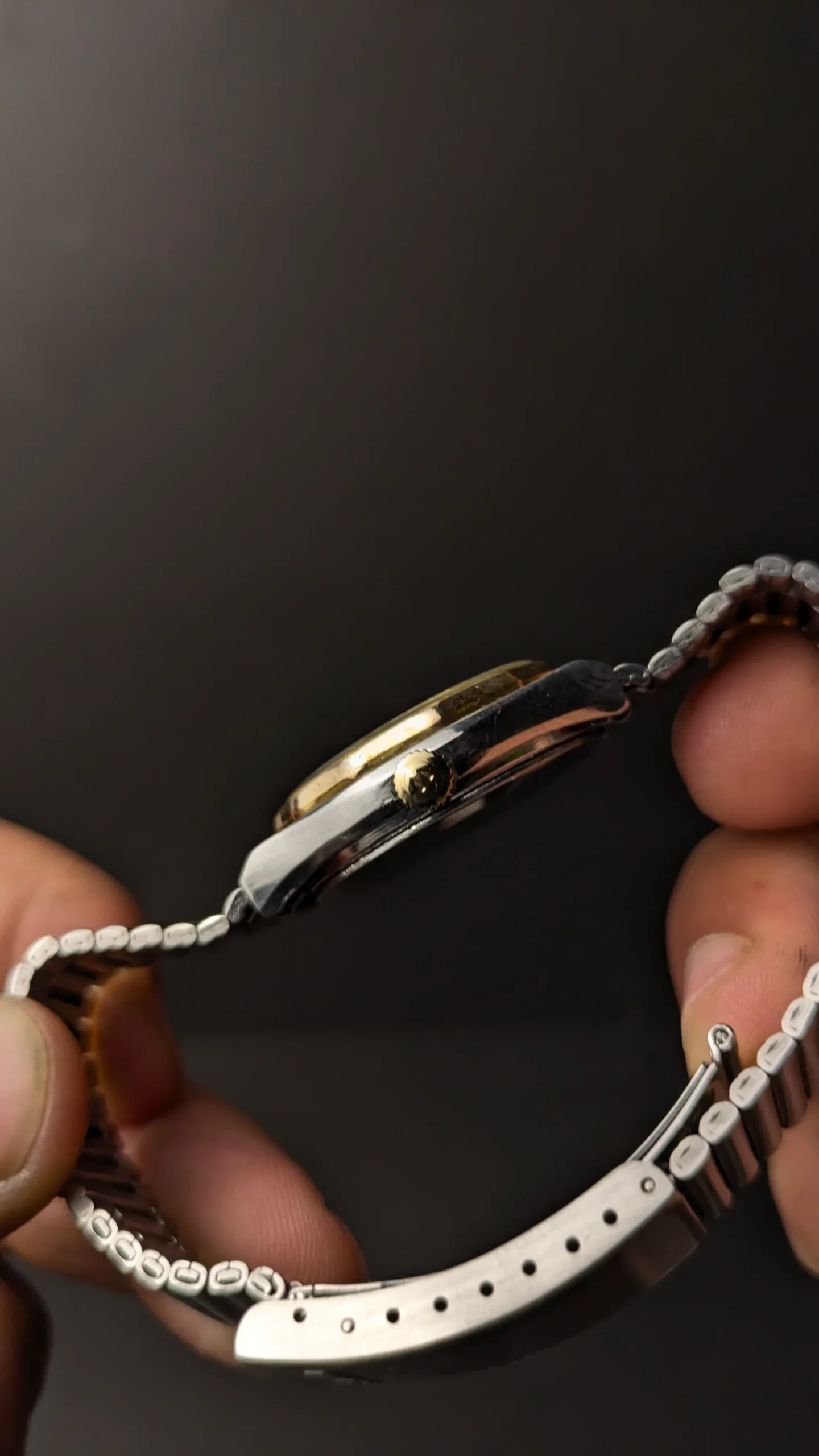 Side profile of vintage automatic wrist watch showing slim case thickness