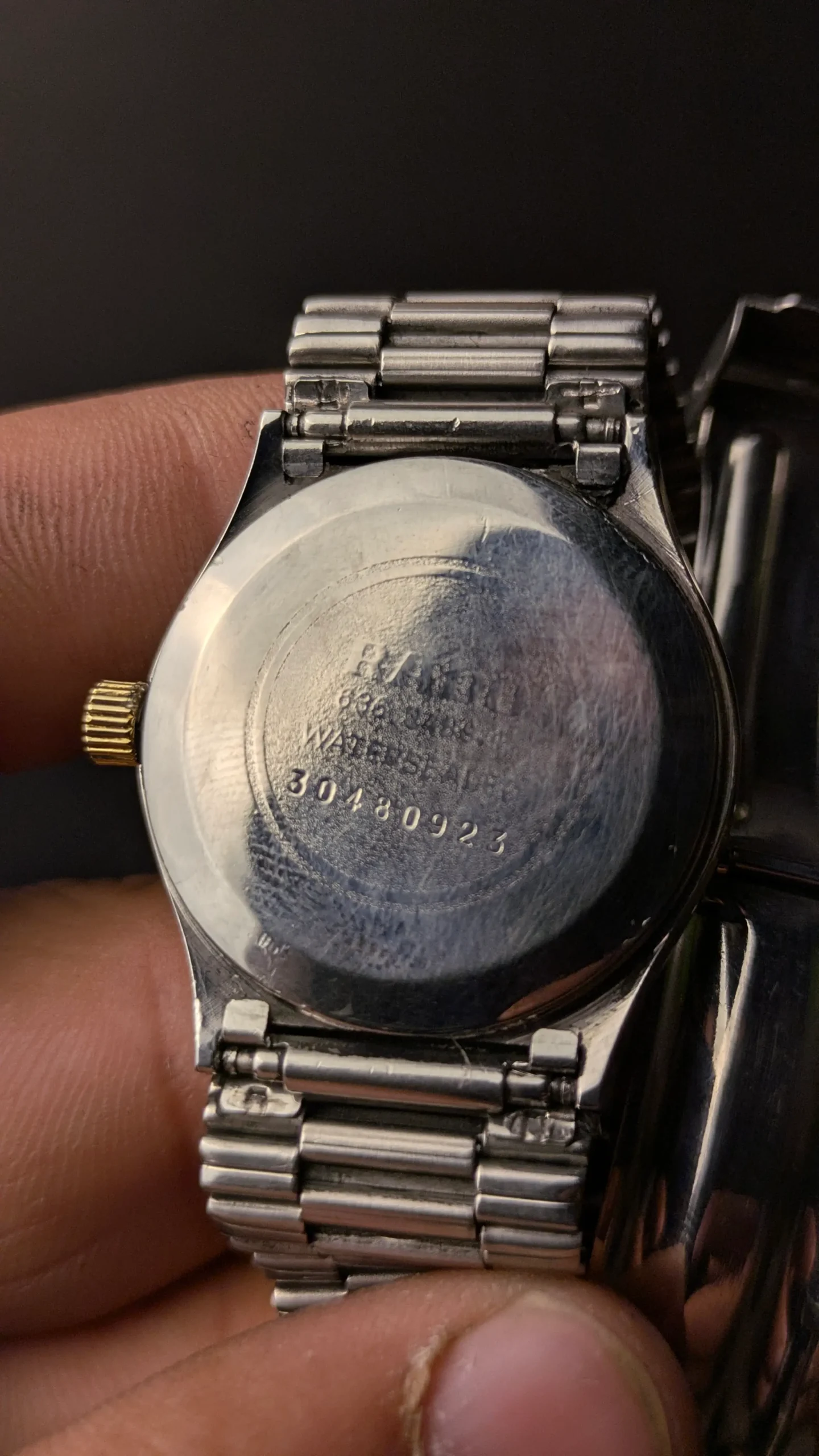 Close-up of RADO watch back case showing engraved serial details