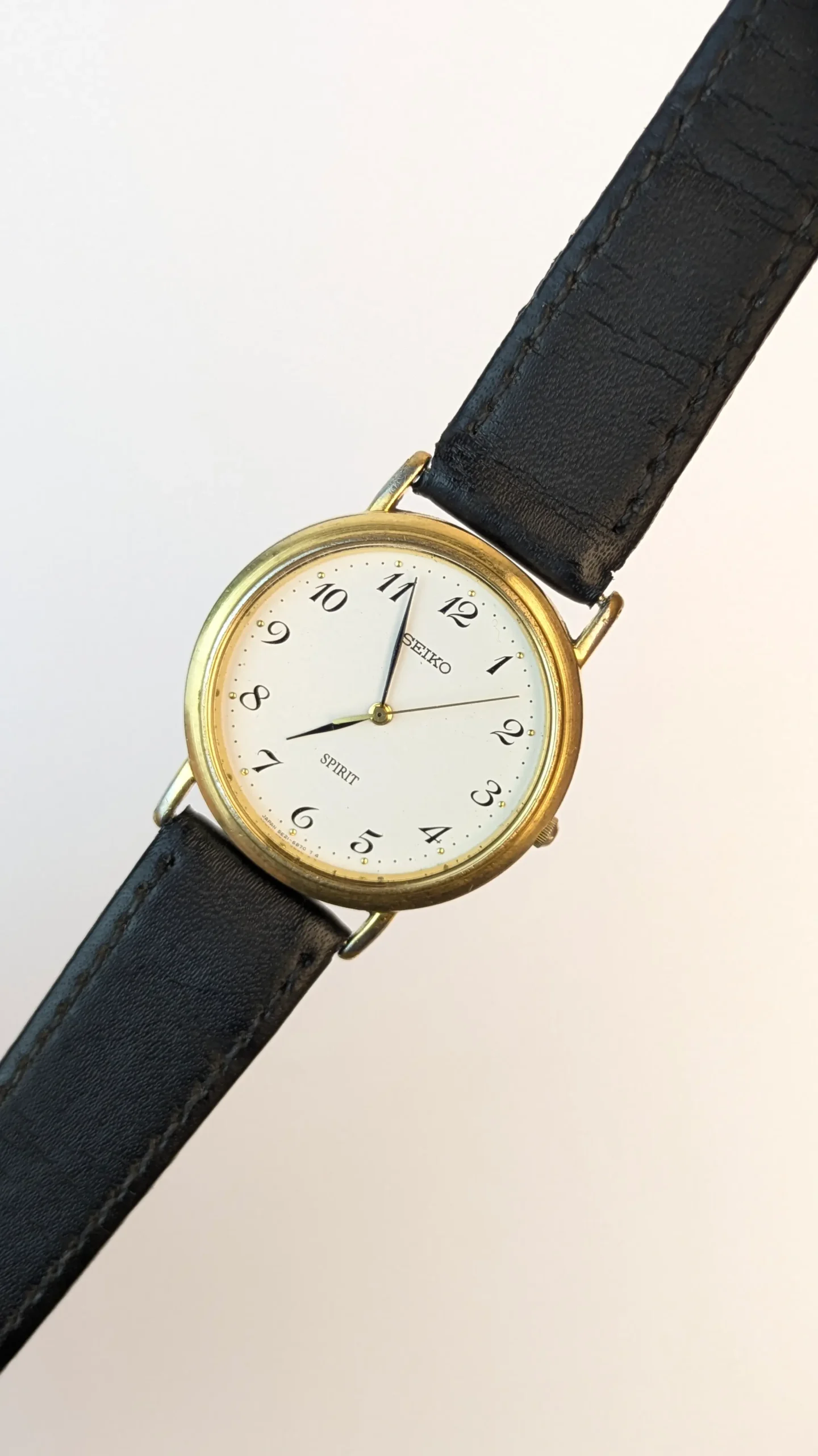 Vintage Seiko Spirit gold-tone wristwatch on wrist