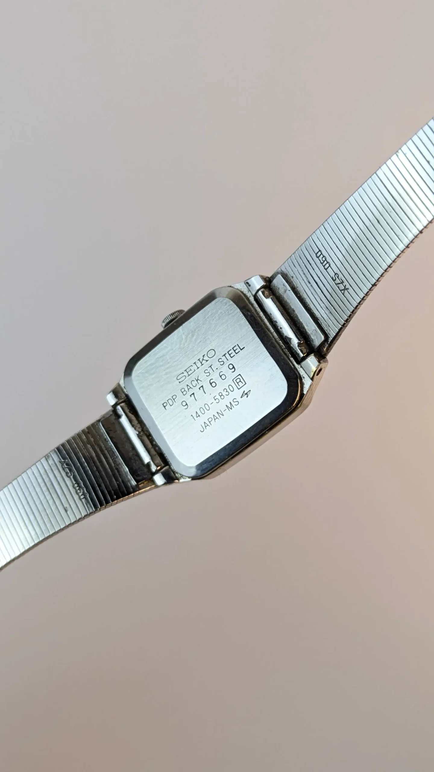 Vintage Seiko Quartz watch case back showing reference 1400-5830 serial 97769 Japan-MS stainless steel