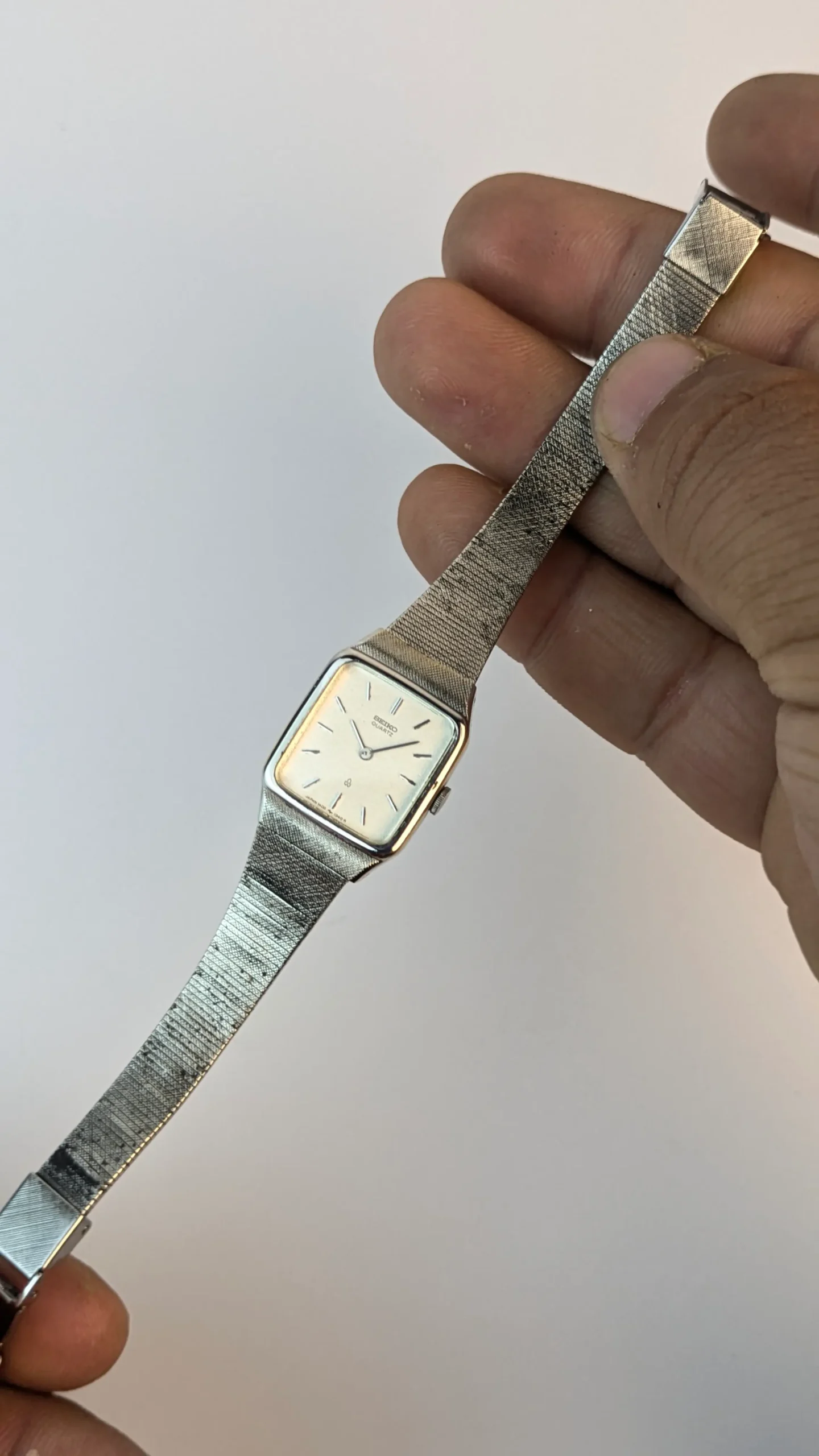 Vintage Seiko Quartz dress watch with silver sunburst dial applied baton indices square cushion case and mesh bracelet