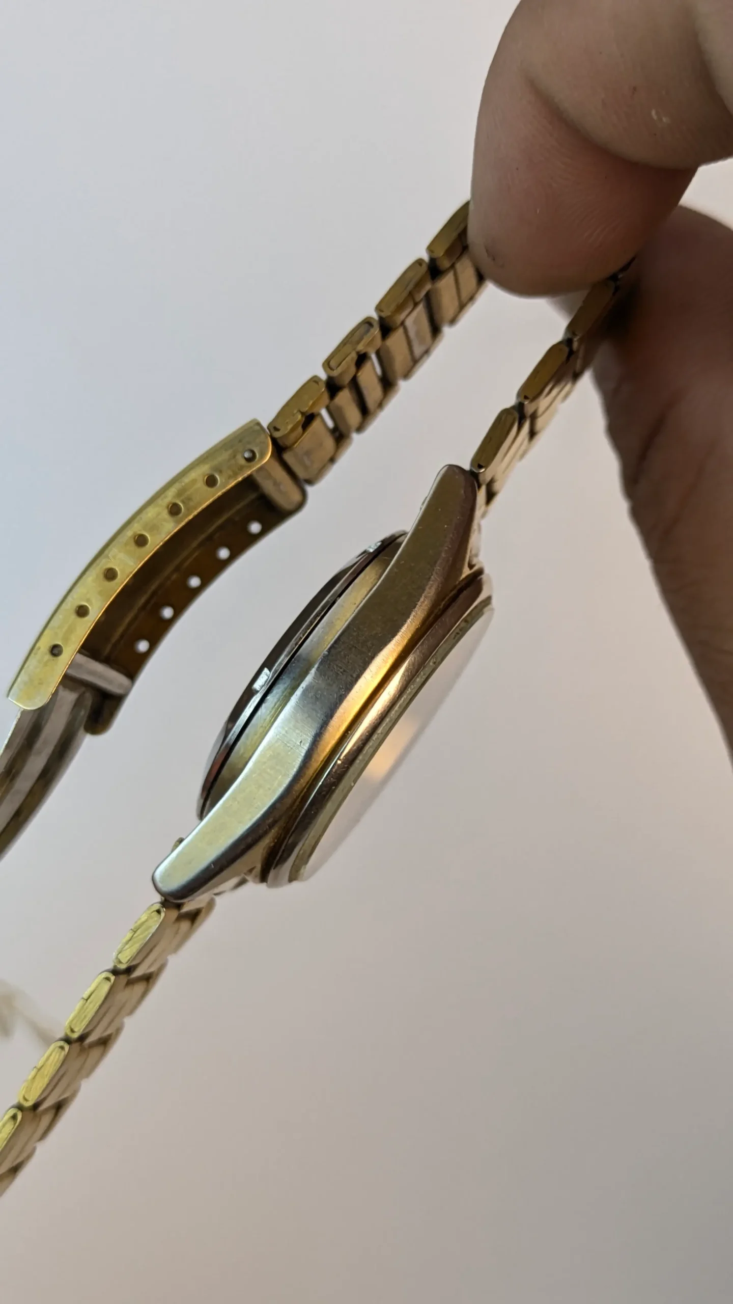 Side profile of vintage Citizen Automatic 34mm round case showing crown and gold tone bracelet