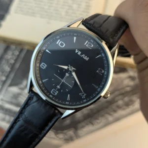 Close up of Vilam black dial dress watch showing white Arabic numerals sub-seconds register and silver sword hands