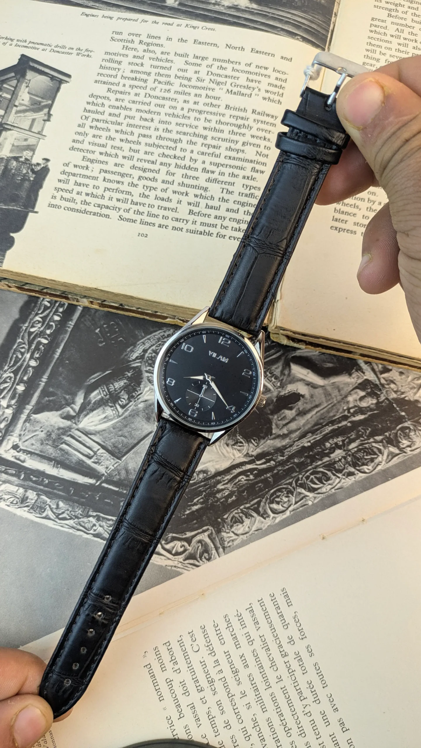 Vilam Classic 40mm black dial dress watch with croco leather strap displayed on vintage book pages at Shaban Watches