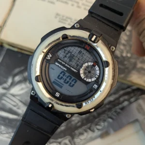 Close up of Sanda digital sports watch with multifunction LCD display and compass inspired tactical dial layout