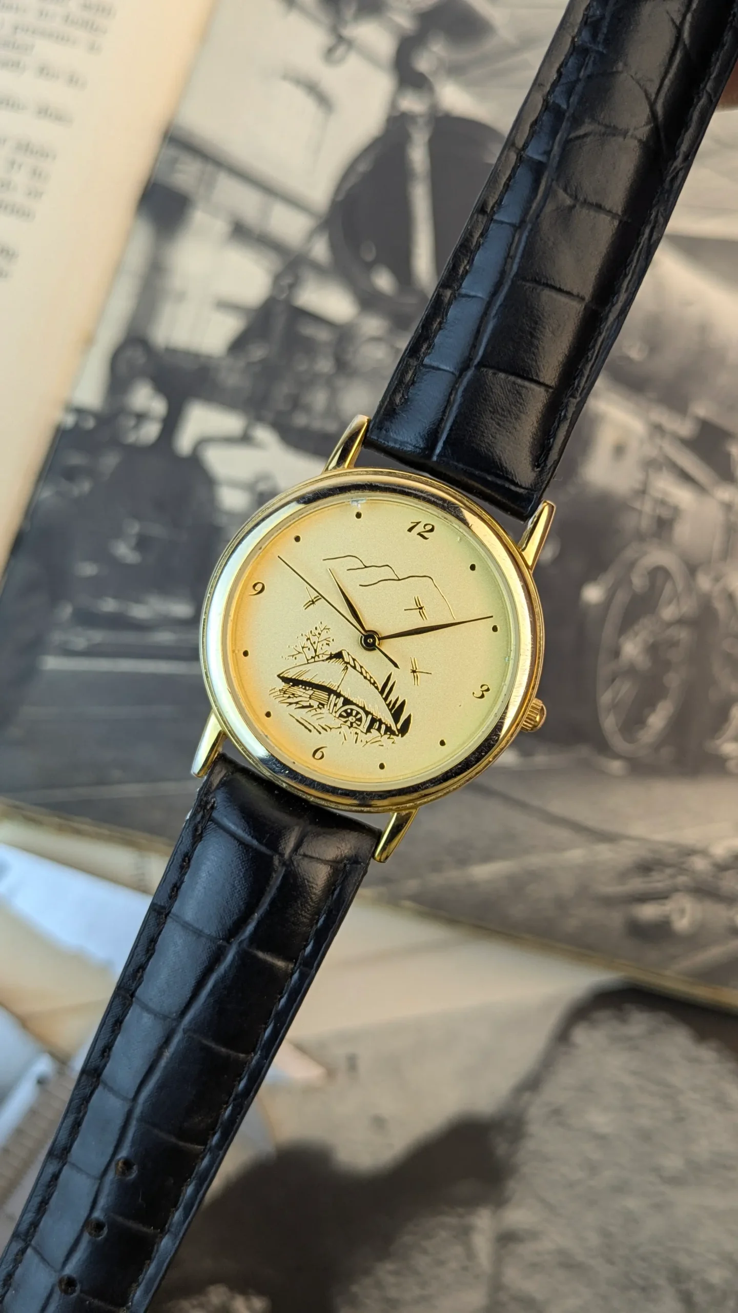 Close-up of artistic countryside hut dial on vintage dress watch