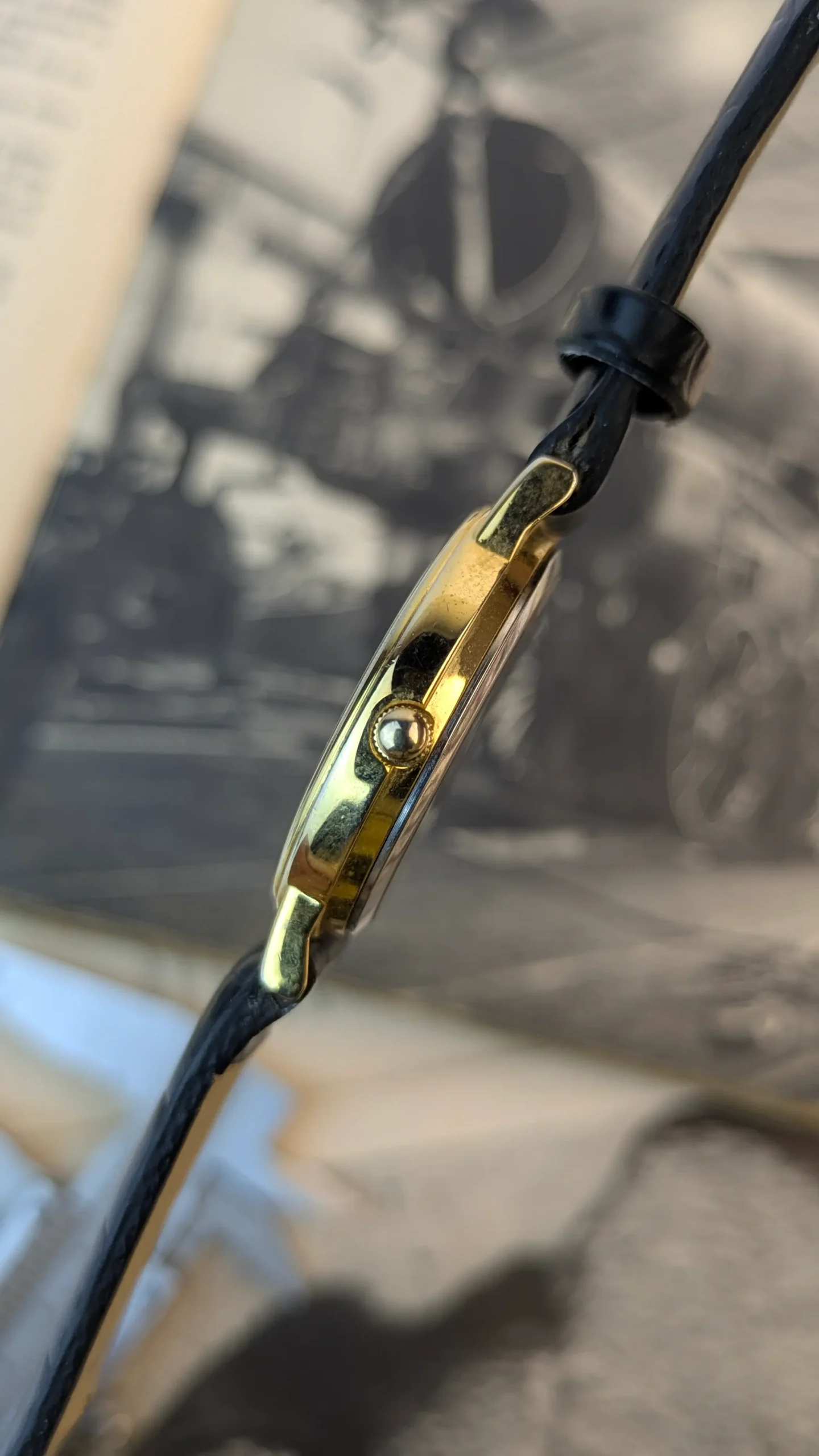 Angled display of vintage gold-tone artistic dial wristwatch
