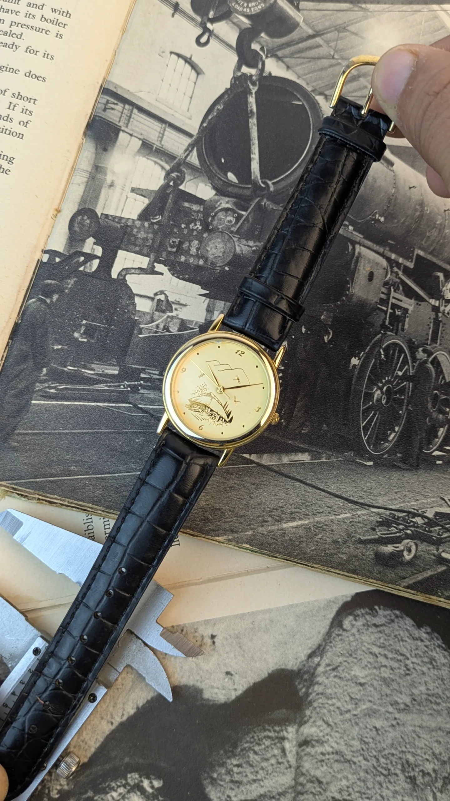 Full display of vintage artistic dial watch with black leather strap