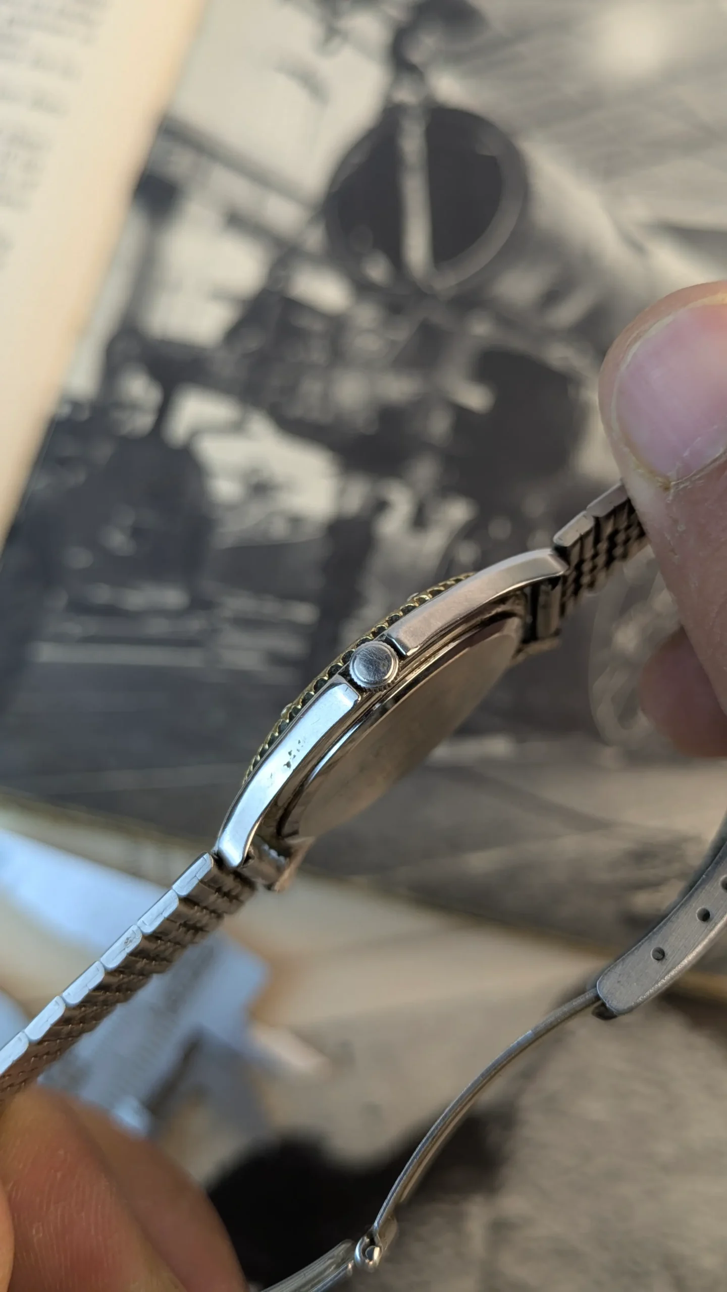 Close-up side view of Aureole vintage quartz watch crown and case profile