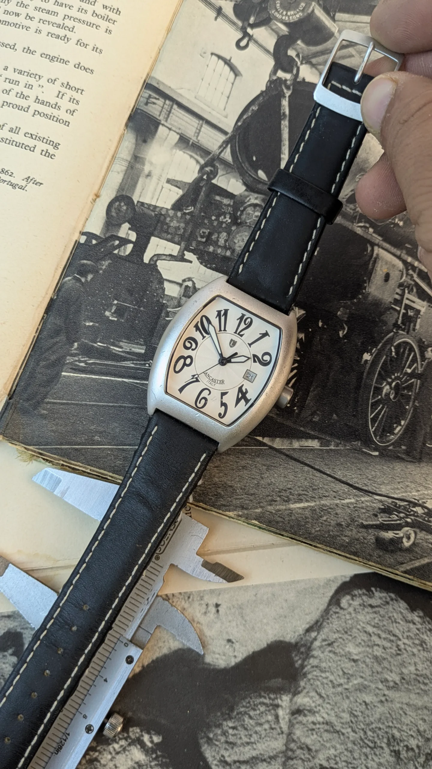Detailed close-up of Lancaster Italy designer quartz watch showing textured silver dial and black leather strap