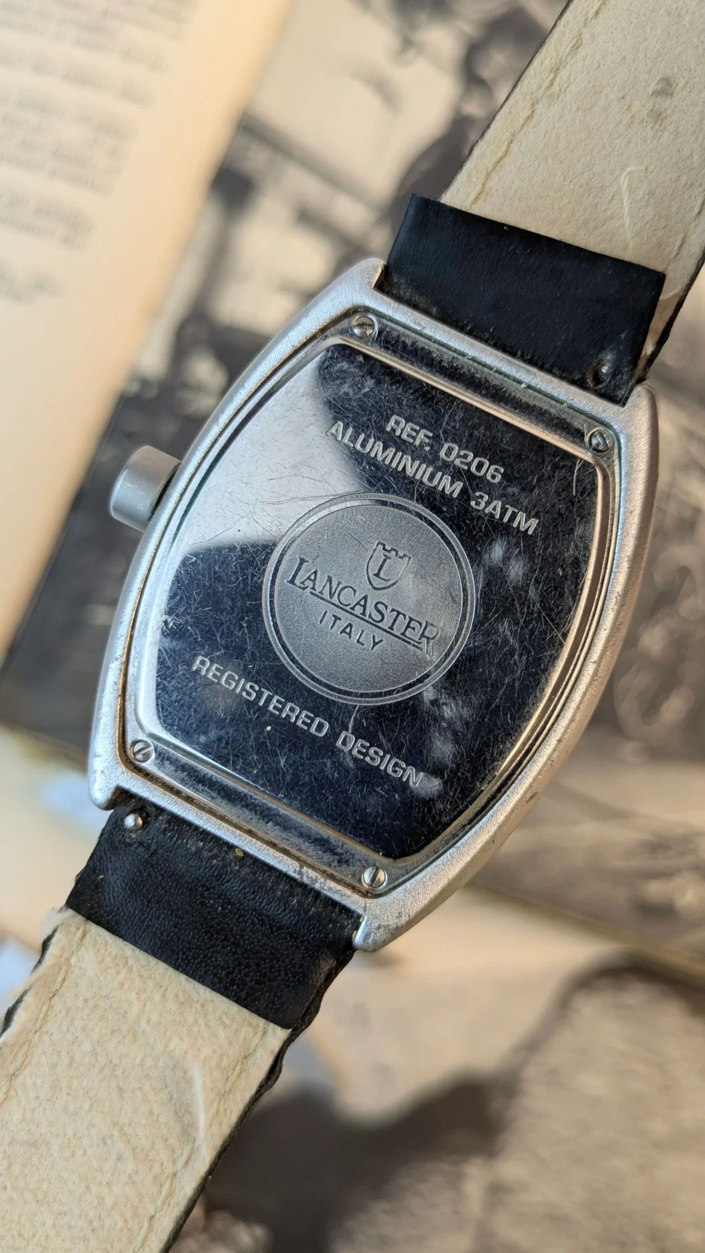 Back case of Lancaster Italy curved designer quartz watch showing REF 0206 and aluminium 3ATM engravings
