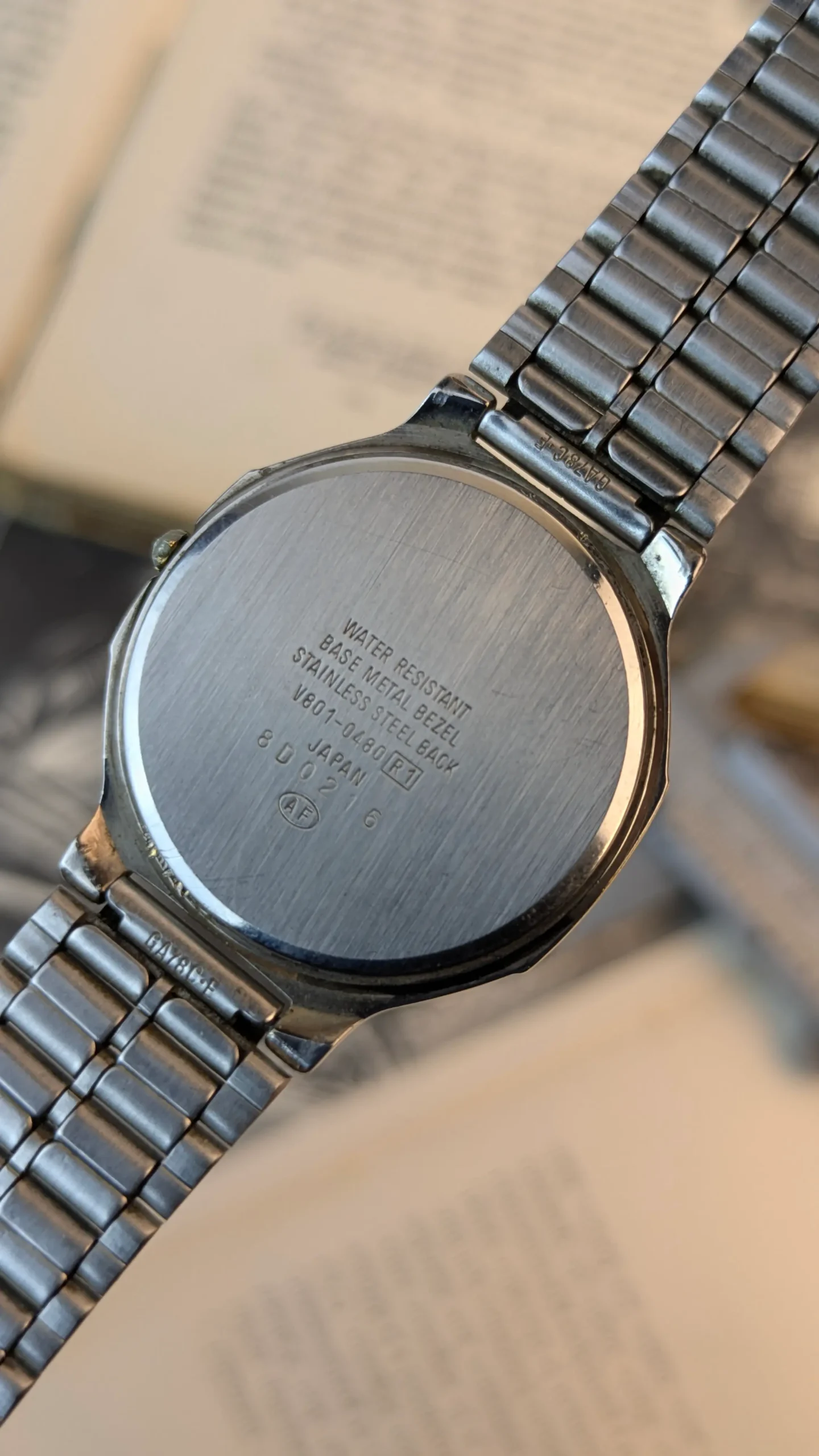 Back case of vintage ALBA Urban quartz watch showing model and serial markings.