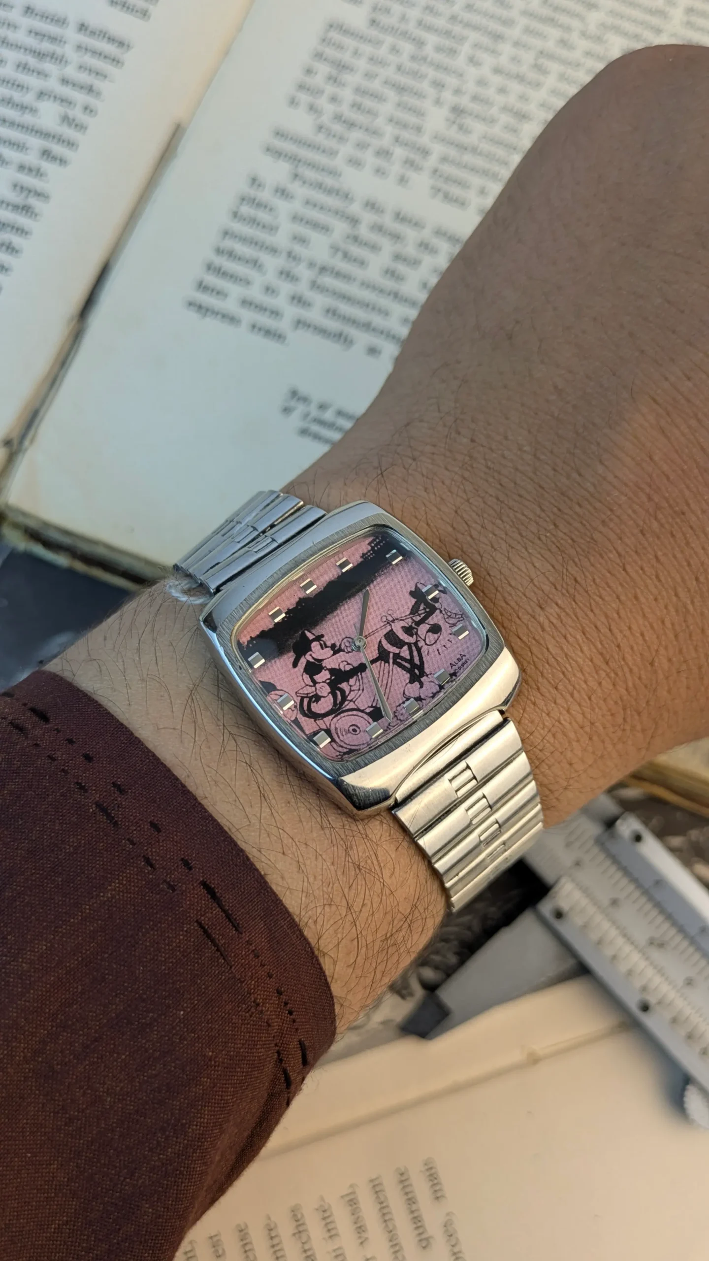 ALBA Disney watch worn on wrist showing pink character dial.