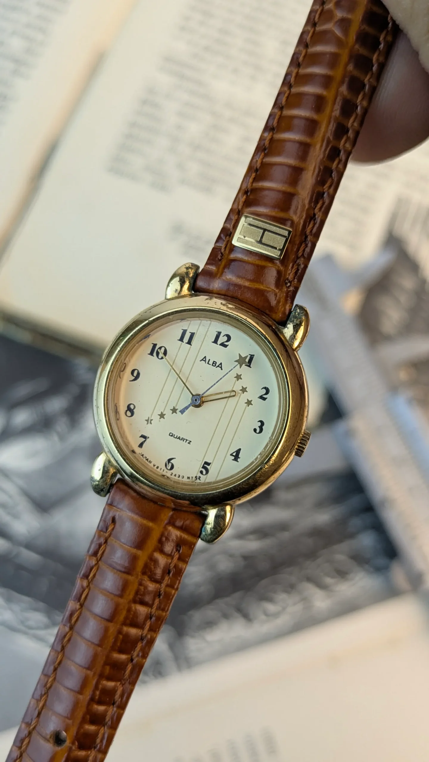 Front view of ALBA ladies watch with cream dial and star motif design.