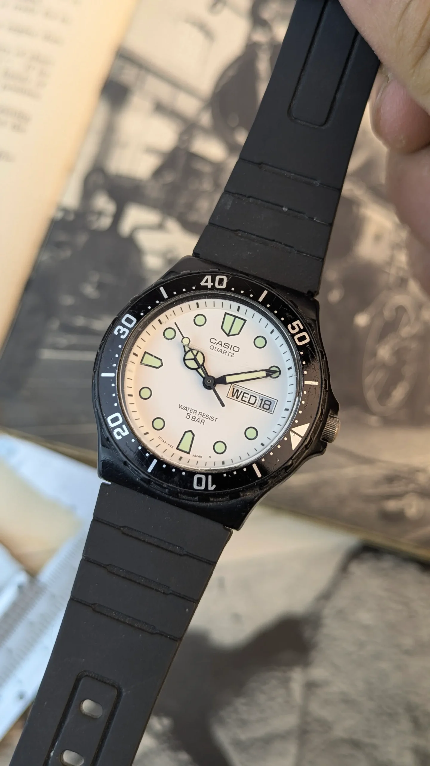 Casio MRW-200H quartz watch with white dial and black resin strap worn on wrist.
