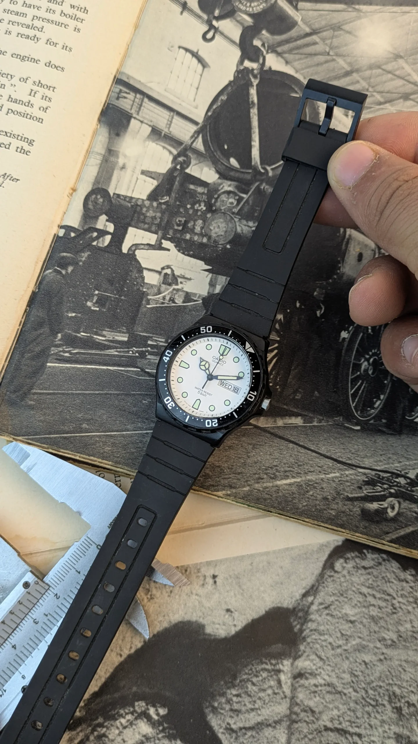 Full view of Casio MRW-200H watch featuring diver-style bezel and black resin strap.