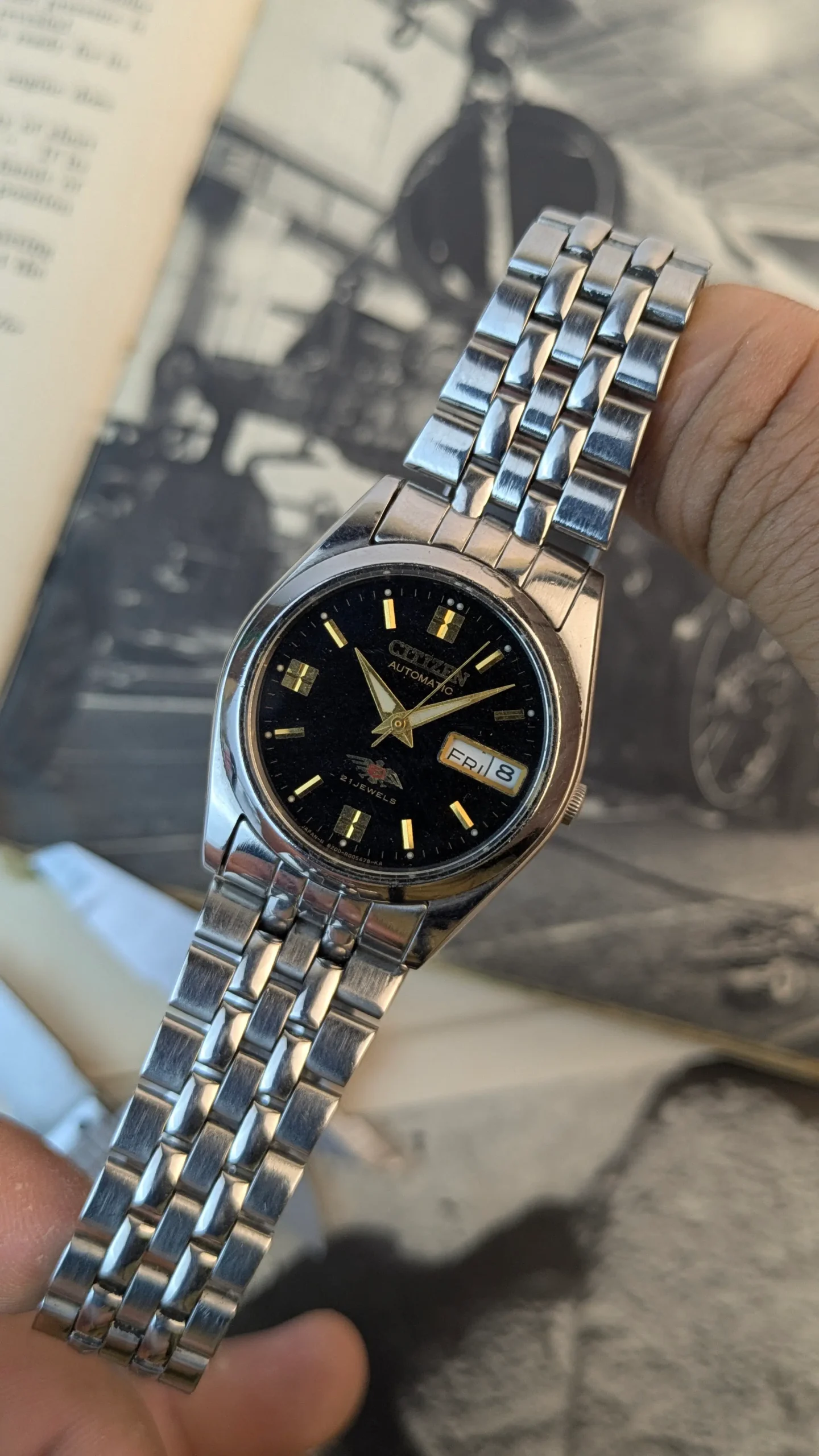 Vintage Citizen automatic wristwatch with stainless steel bracelet and black dial.