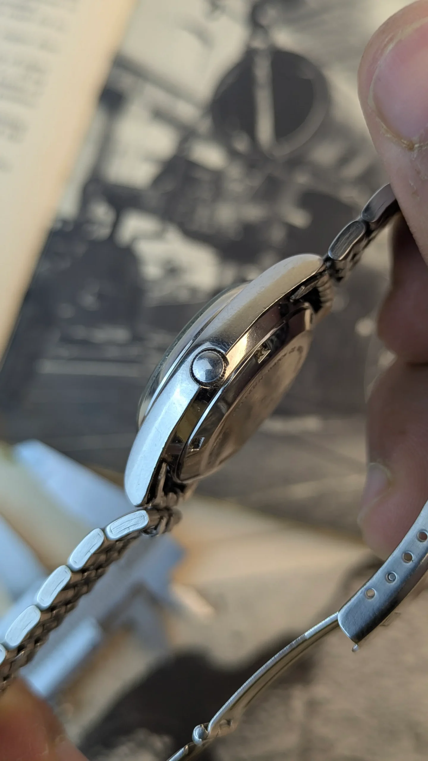 Crown side detail of Citizen automatic day-date watch with stainless steel case.