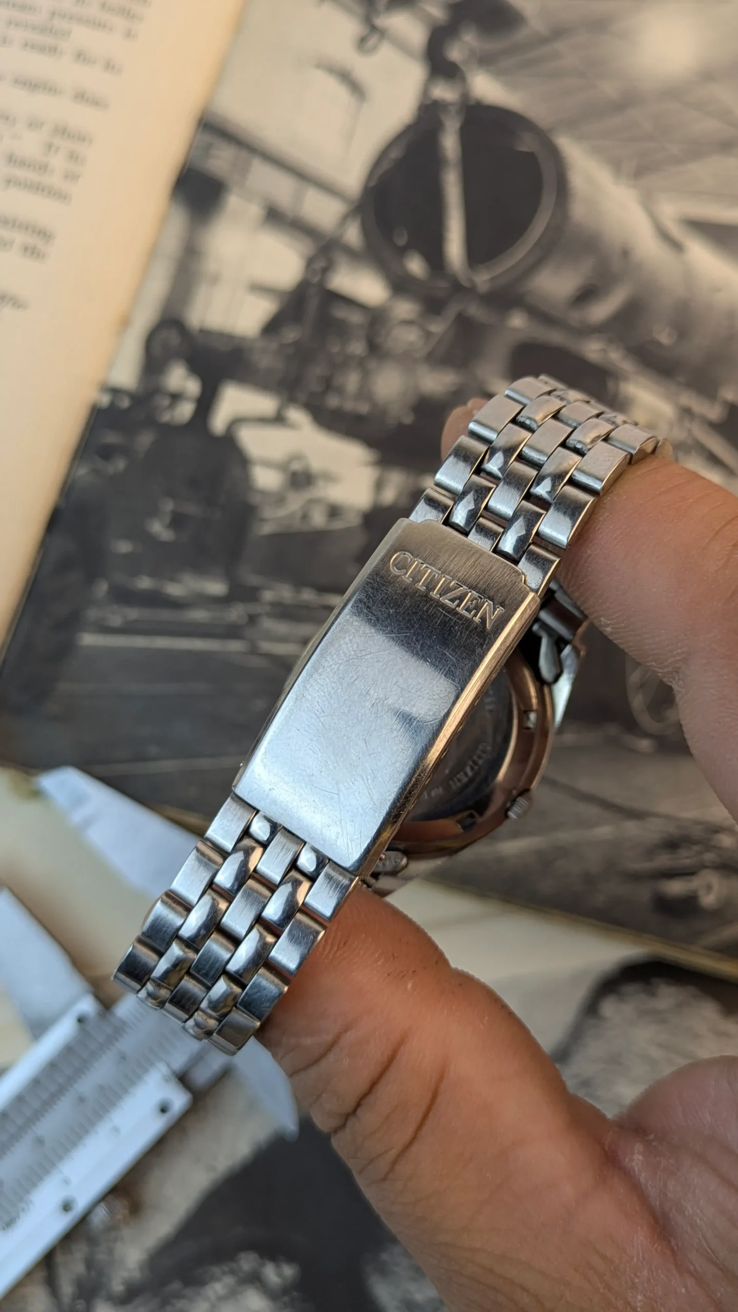 Citizen signed stainless steel bracelet clasp on vintage automatic wristwatch.