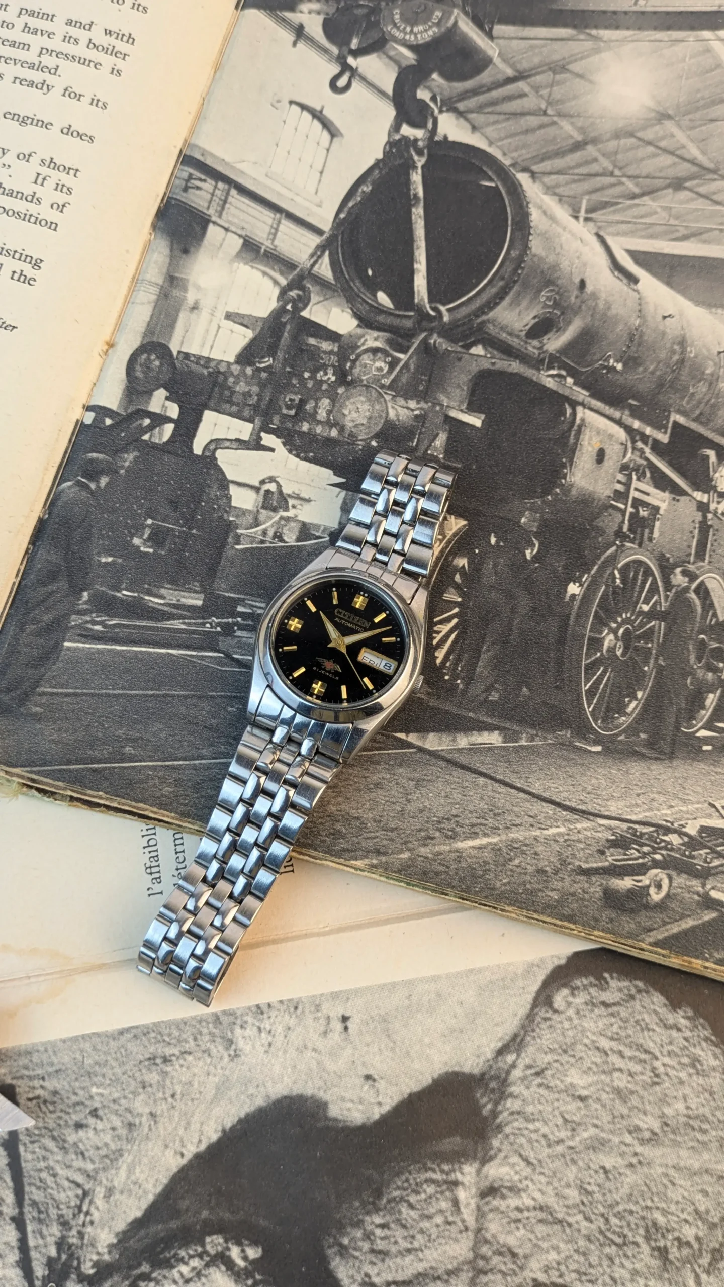 Vintage Citizen Automatic 21 Jewels day-date watch with black dial and stainless steel bracelet worn on wrist.